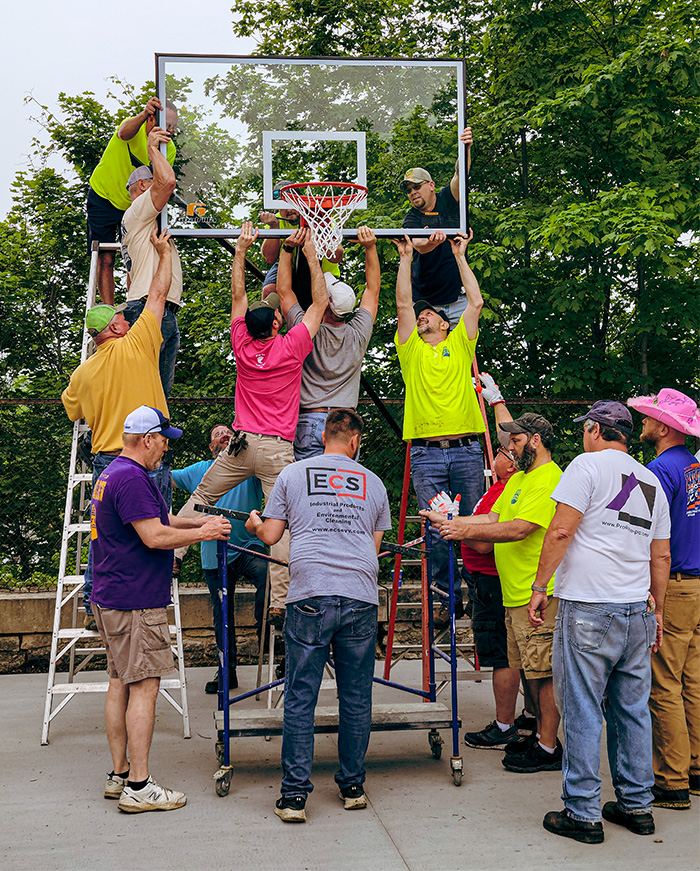 Volunteers Working On Basketball Goal